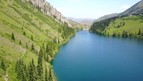Kolsay Lake Among Green Hills and Mountains