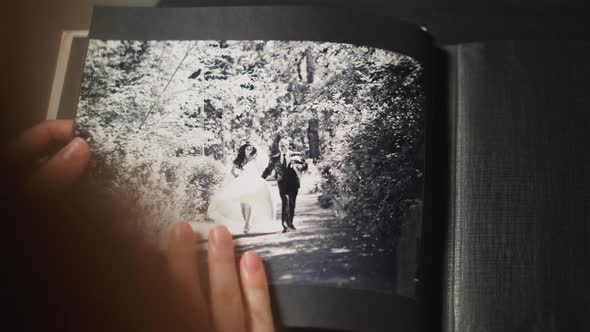 Woman Looks at Vintage Picture of Grandparents Wedding