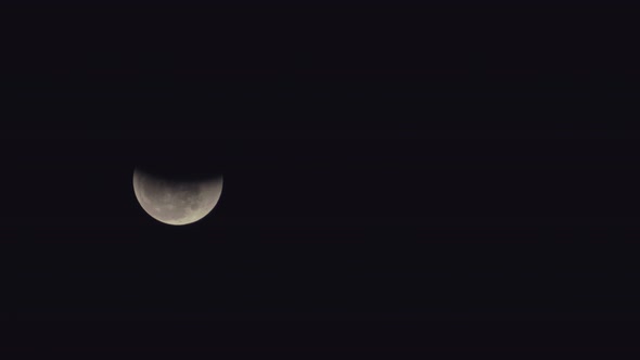 Telephoto view of the mooning across the night sky during an eclipse