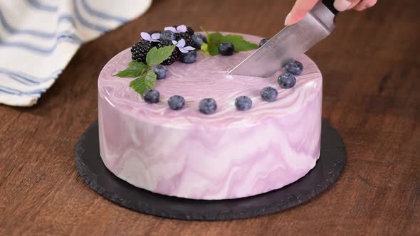 Cutting Berry Mousse Cake With Mirror Glaze.