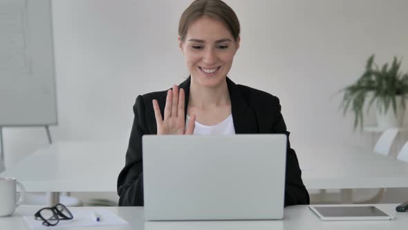 Online Video Chat by Young Businesswoman on Laptop