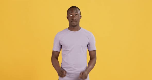 Cheerful Black Man Pointing and Looking Upward at Something