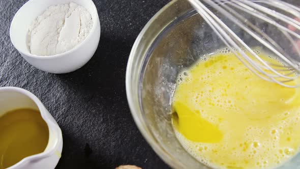 Woman whisking egg in bowl