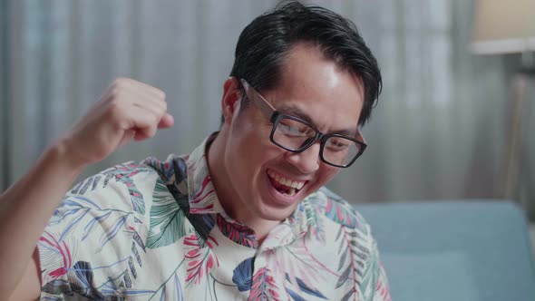 Close Up Of Asian Man Composer With A Guitar Celebrating For Finishing Composing Music On Paper