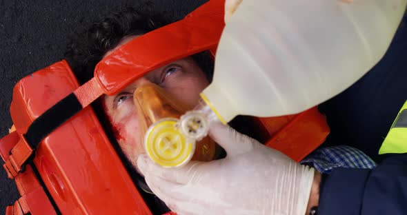 Emergency medical technician placing an oxygen mask