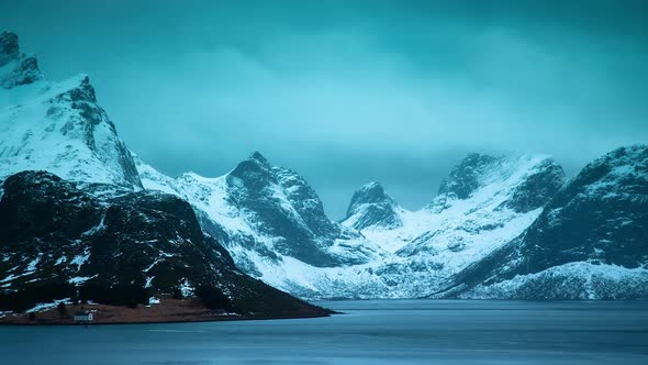 TIME LAPSE - Snowy mountain lake in Lofoten Islands, Norway, wide shot zoom in