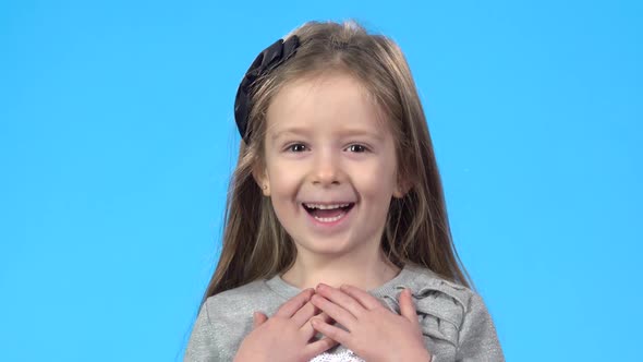 Little Girl Is Looking Overjoyed, Smiling and Showing Thumb Up.