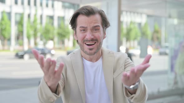 Outdoor Portrait of Young Man Reacting to Loss