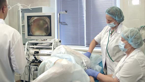 Doctors Conducting Surgery Using Endoscope