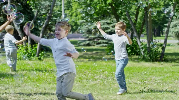 Laughing Kids Catching Soap Bubbles