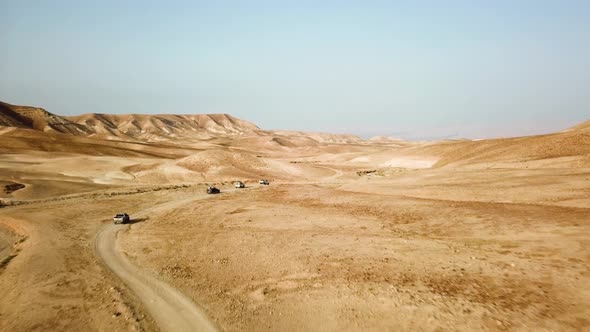 A convoy of Vehicles along the Desert in the Middle East