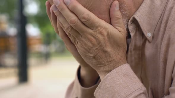 Aged Pensioner Crying Close-Up, Covering Face With Hands in Despair, Sorrow