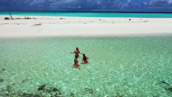 Tourists relaxing on exotic lagoon beach lifestyle by clear sea with white sand background of the Ma