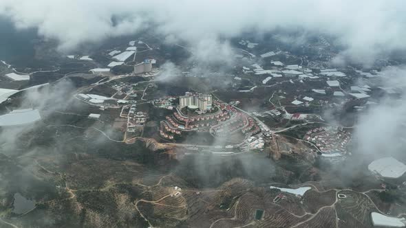 Over the city in the clouds aerial view 4 K