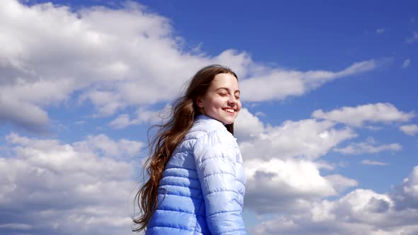 Happy Child with Long Hair in Autumn Jacket Enjoy the Sun on Sky Background Haircare