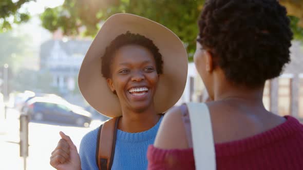 Twin sisters standing together in the city 4k