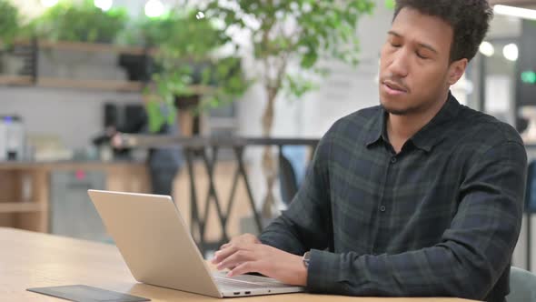 African American Man with Laptop Having Back Pain