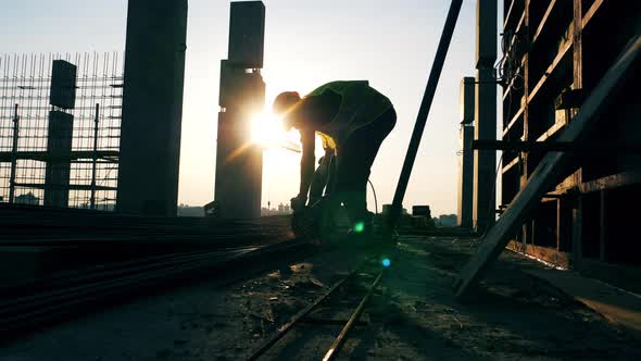 Building Site with an Engineer Welding Metal Stems