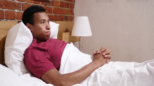 Disturbed Angry Frustrated African Man Lying in Bed Devastating
