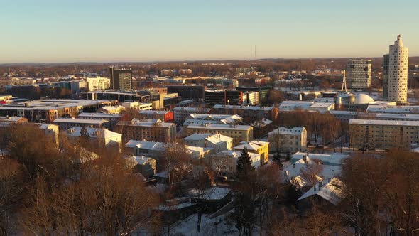 Drone shot over snowy roof tops of Karlova district towards to Snail tower Tigu torn