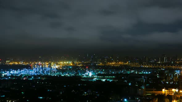 time lapse Petroleum plant at night cityscape on storm cloudy sky with dangerous lightning bolt