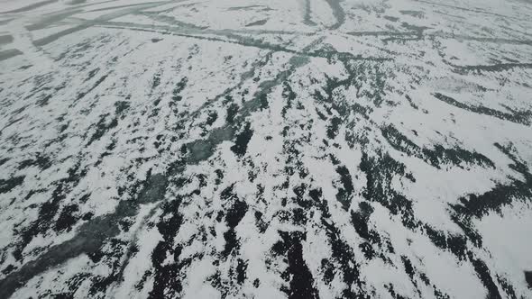 Winter Season Snowy Camera Flies Over a Frozen River Arctic Landscape Aerial Shot