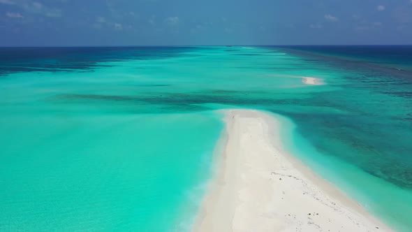Aerial top down panorama of exotic resort beach holiday by shallow ocean with white sandy background