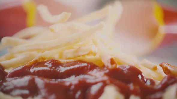 Pile of French Fries or Deepfried Potatoes and Tomato Ketchup