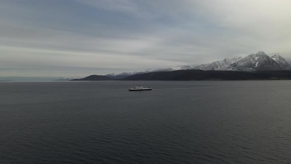 Ferry cruising in the Arctic ocean, snowy mountains in Northern Norway