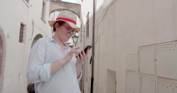 Beautiful Woman using Mobile Phone while have a walk in the city