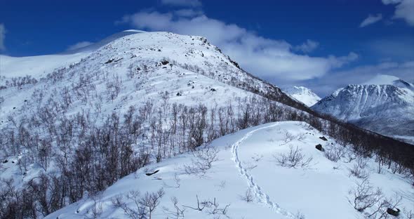 Revealing Scenic landscape with snow covered mountains in Norway, low flyover, Scandinavia