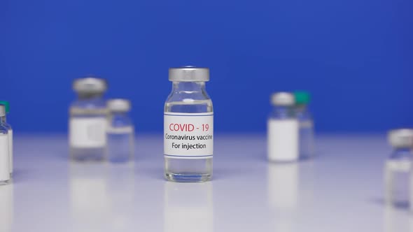 Bottle Vaccine Against SARSCoV2 Virus on Background Laboratory Table