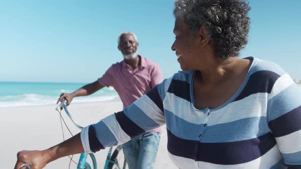 Senior couple with bikes at the beach