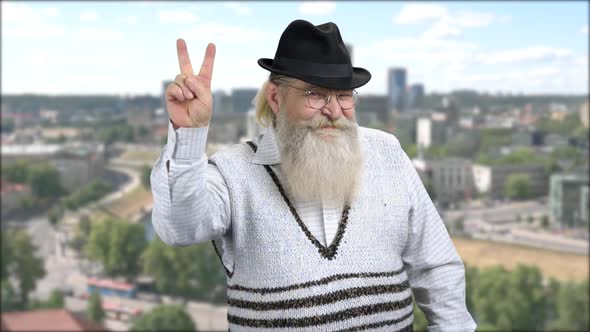 Cheerful Senior Man Showing Peace Gesture