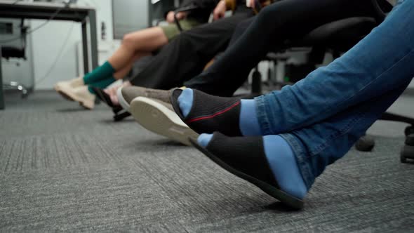 Many people in office cross their legs and put one to another. Unrecognizable persons in socks