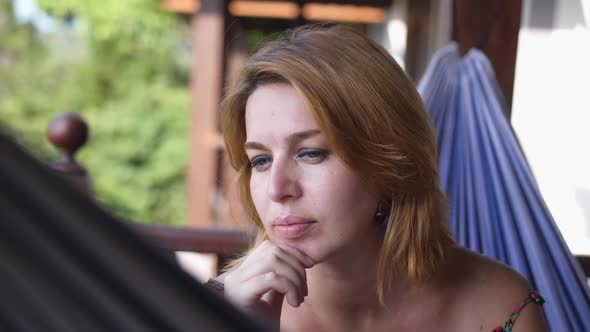 Attractive Young Woman Rrelaxing in a Hammock