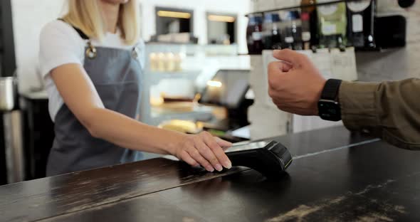 Man Hand with Smartwatch Using Terminal for Payment Noncash Transaction Side View