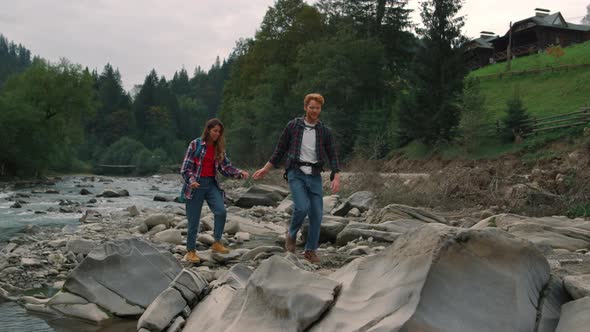 Couple Hiking Along Mountain River