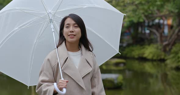 Woman bring of umbrella in the park