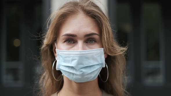 Woman in Mask Look at Camera Closeup Coronavirus. Person Wearing Masks Covid-19.