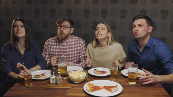 Friends at Home Eat Pizza Looking Upset Watching Sport Game on Tv