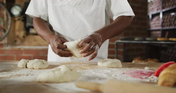 Animation of hand of african american male baker preparing sourdough for bread