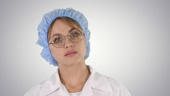Medical doctor woman going on gradient background