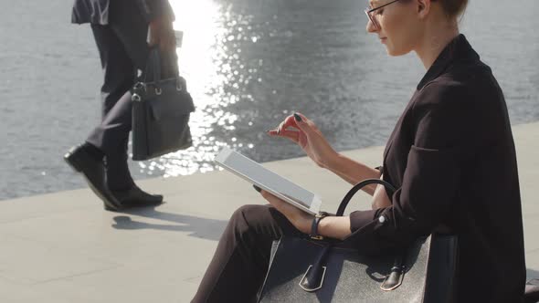 Business Woman Working On Tablet By River