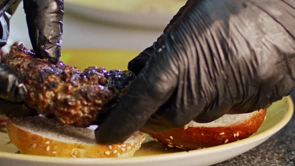 Slow motion of beef hamburger placed on a bun