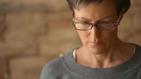 Face of Mature Beautiful Woman Using Laptop with Eyeglasses