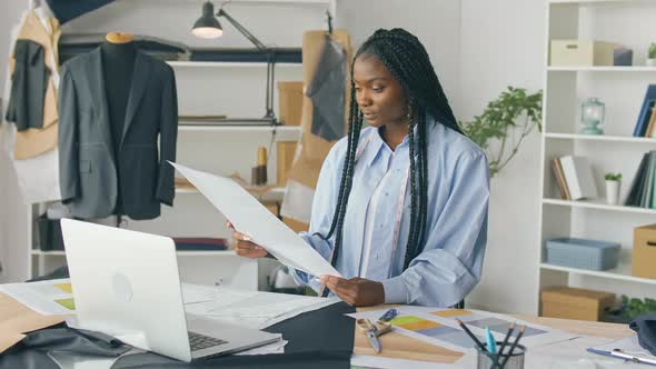 Businessmantailor AfricanAmerican Girl Works with Sketches of Clothes