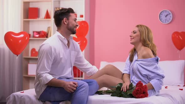  Man Proposing to Surprised Girlfriend Giving Ring and Bunch of Roses