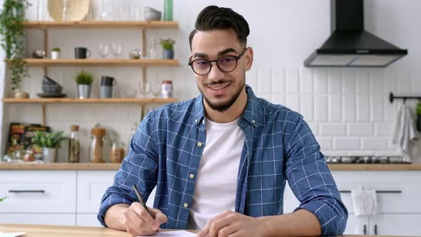 Friendly Positive Arabian or Indian Modern Guy Clever Student or Freelancer with Glasses Listening