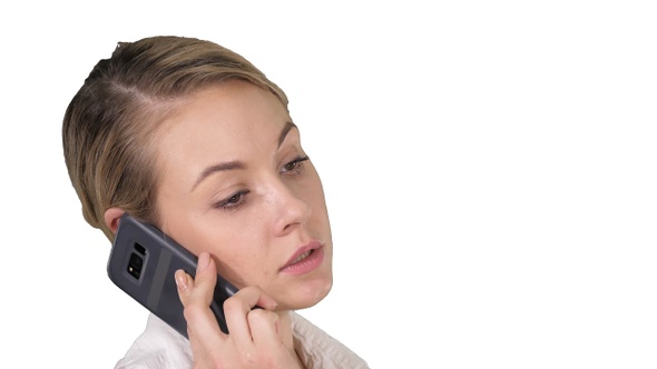 Woman with blonde hair talking on cellphone on white background.